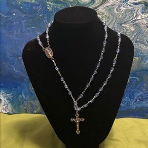 blue glass beaded rosary with silvertone crucifix and a Miraculous Medal.